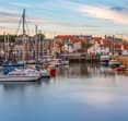 fife coastal town with boats in foreground